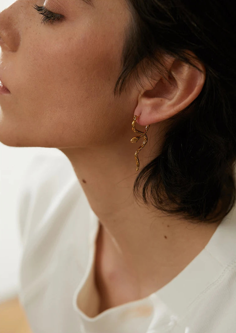 gold snake earring worn show how it complements the ear