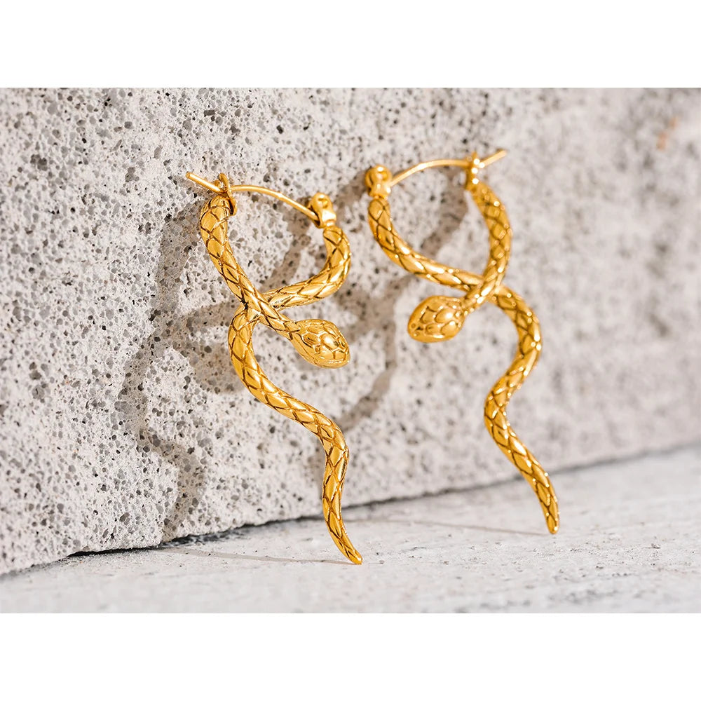 Close-up of gold snake earring highlighting its elegant curves