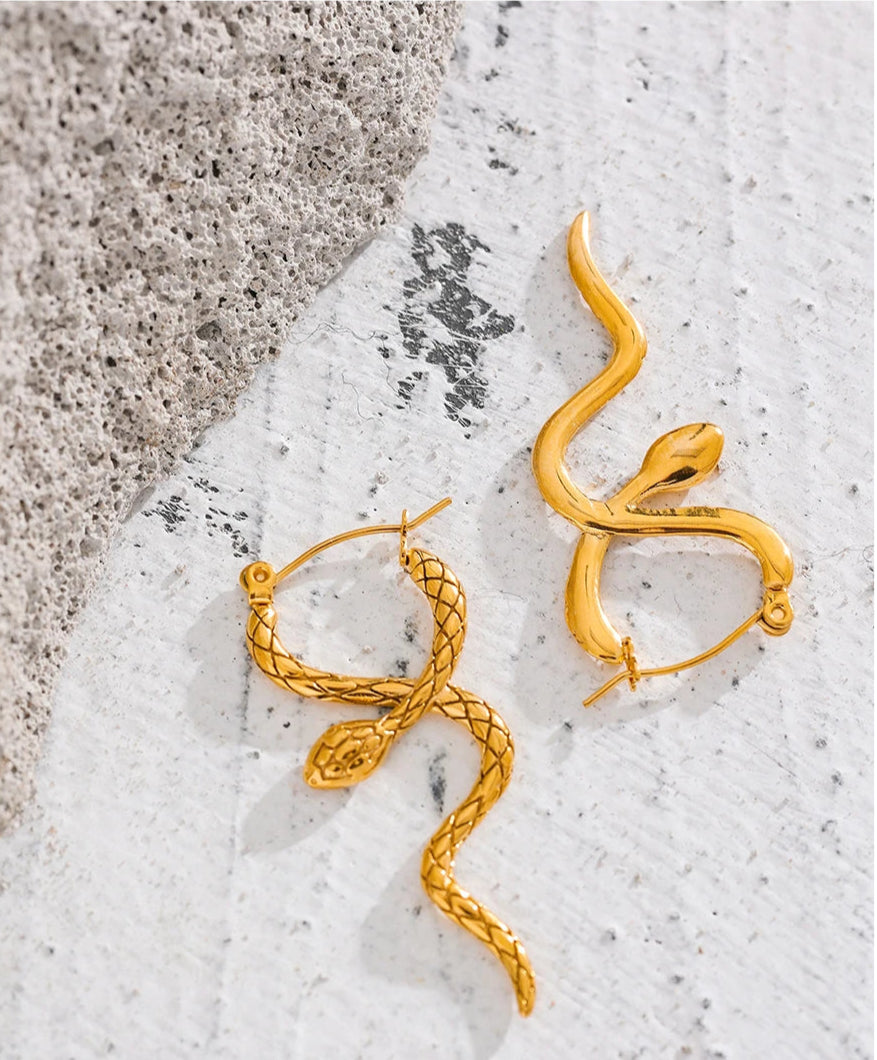 Detailed shot of snake earrings, reflecting their unique and artistic design