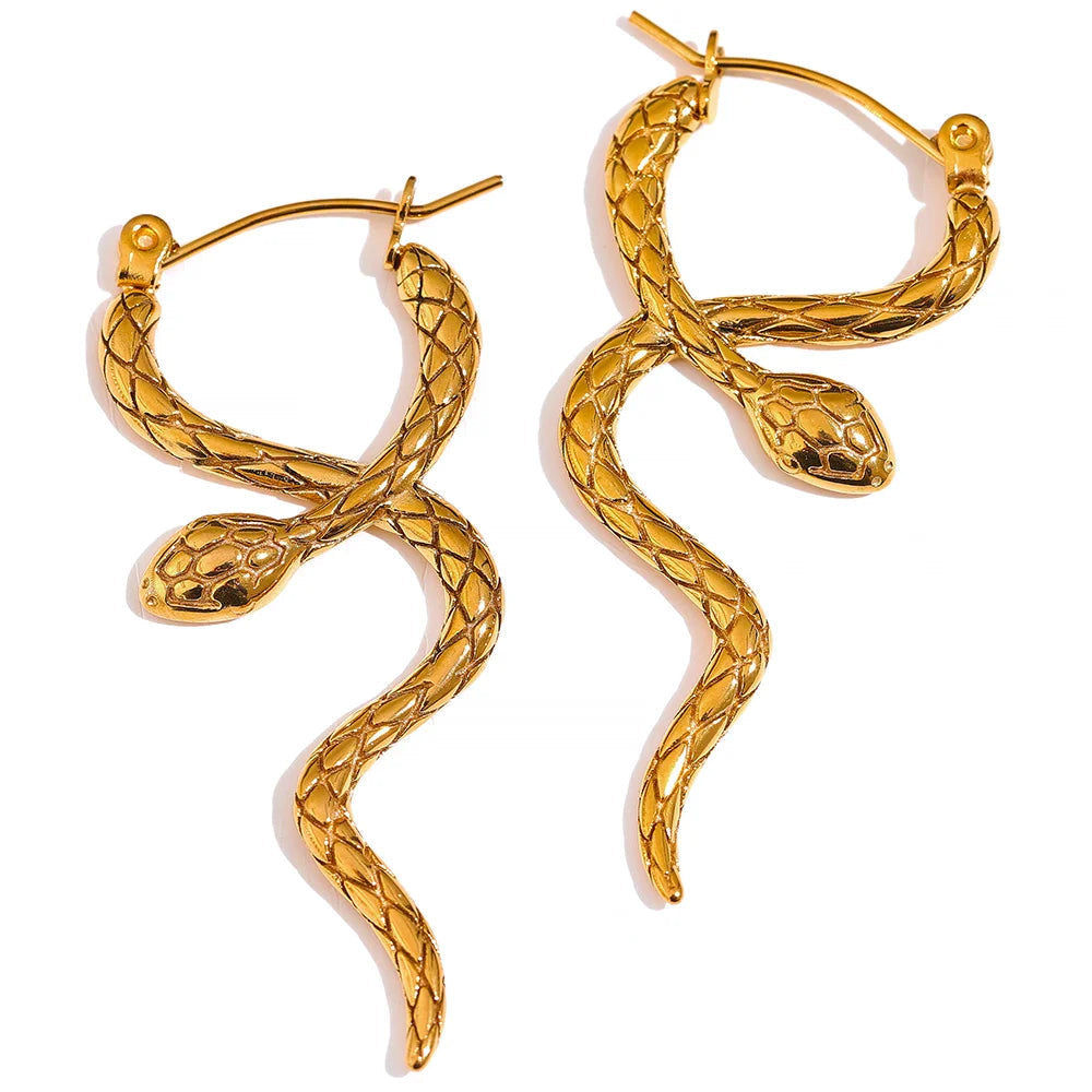 Elegant snake-inspired earrings displayed, showcasing their detailed craftsmanship